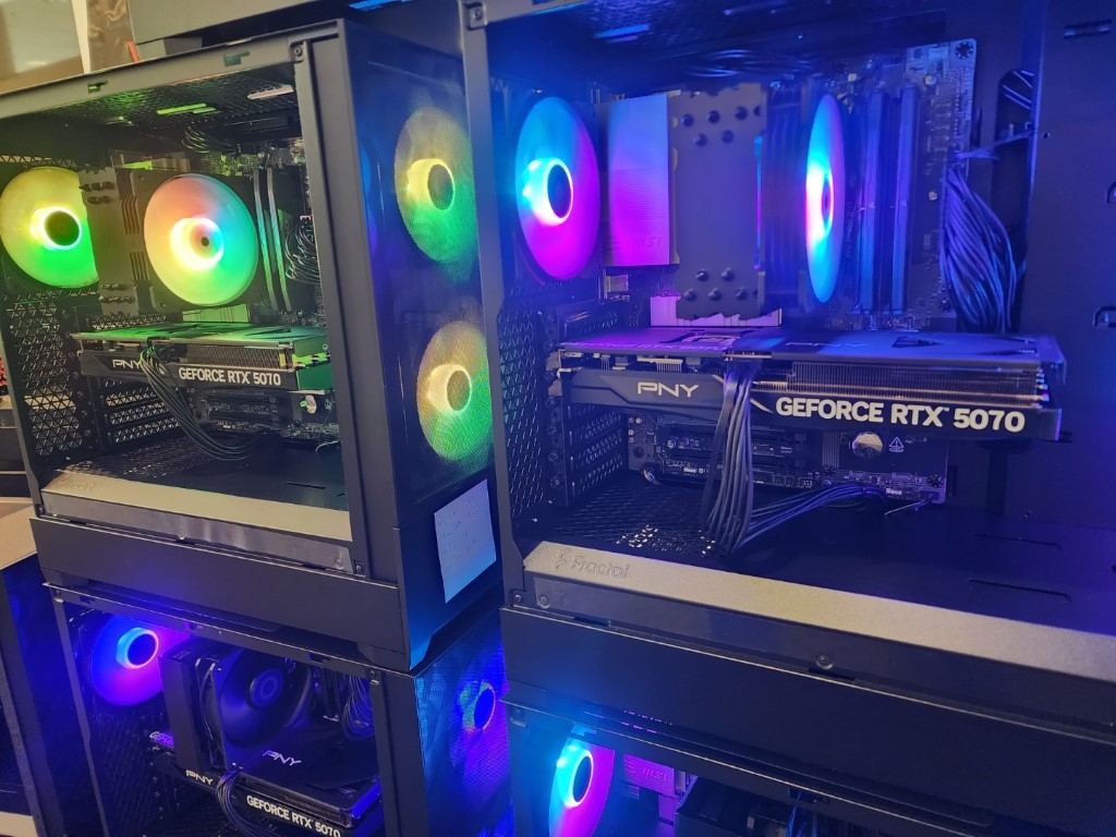 Two stacked Fractal towers with green-yellow and blue-purple RGB fans, each holding a PNY RTX 5070