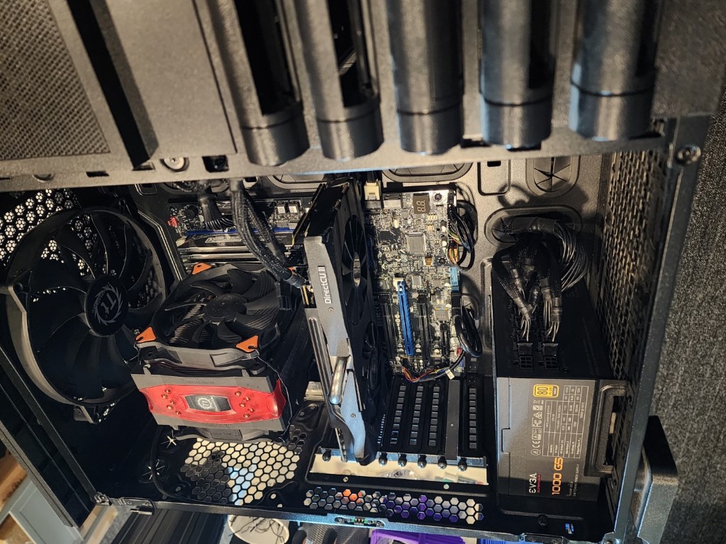 Interior of a custom build: EVGA 1000 G5 PSU, ASUS motherboard with OLED screen, and DirectCU II graphics card
